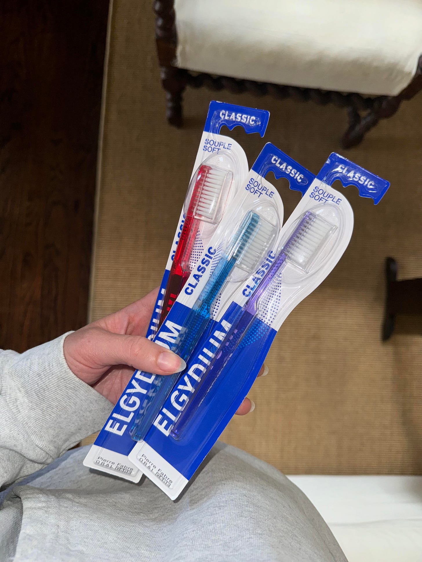 Three packaged toothbrushes