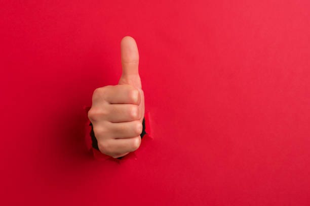 Human hand showing thumbs up stock photo