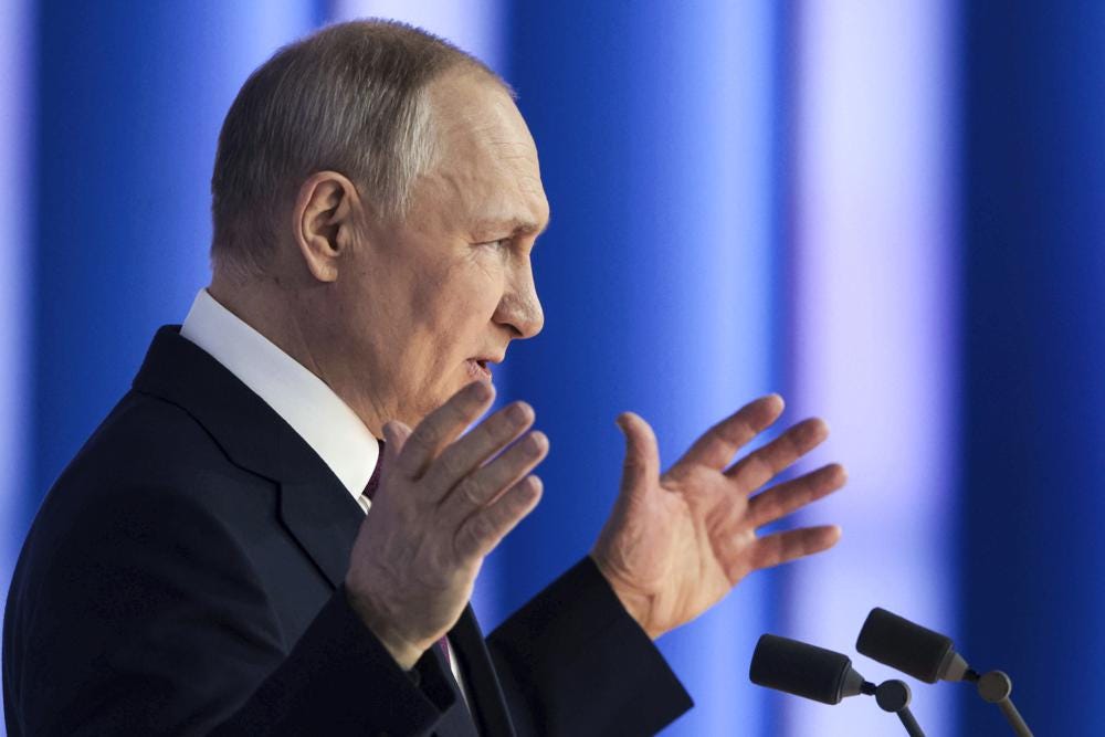Russian President Vladimir Putin gestures as he gives his annual state of the nation address in Moscow, Russia, Tuesday, Feb. 21, 2023. (Mikhail Metzel, Sputnik, Kremlin Pool Photo via AP)