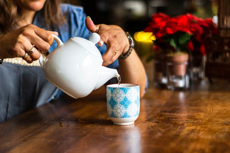 Pouring tea into a cup Pouring tea into a cup