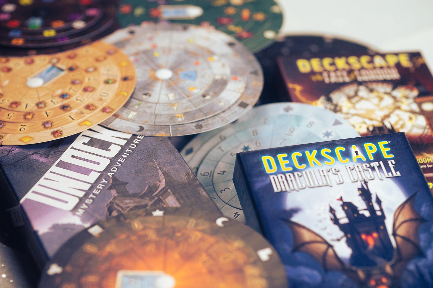 Decoder wheels from the Exit: the Game series, plus Unlock and Deckscape boxes