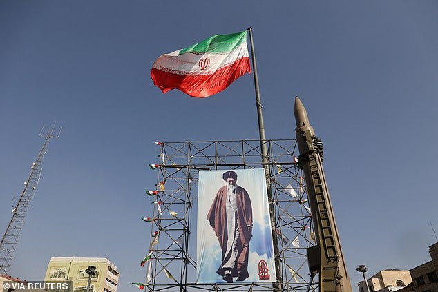 An Iranian missile system is displayed next to a banner with a picture of Iran's Supreme Leader Ayatollah Ali Khamenei, during Iranian defence week, in a street in Tehran, Iran, September 24