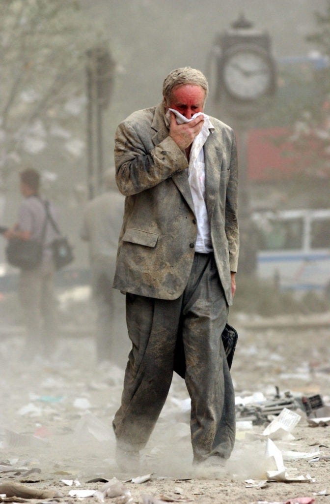 NEW YORK, UNITED STATES: US-WTC-THEN AND NOW-ED FINE 1(FILES) This file photo dated 11 September 2001 shows Edward Fine covering his mouth as he walks through the debris after the collapse of one of the World Trade Center Towers in New York. Fine was on the 78th floor of 1 World Trade Center when it was hit by a hijacked plane 11 September. AFP PHOTO/Stan HONDA (Photo credit should read STAN HONDA/AFP/Getty Images)