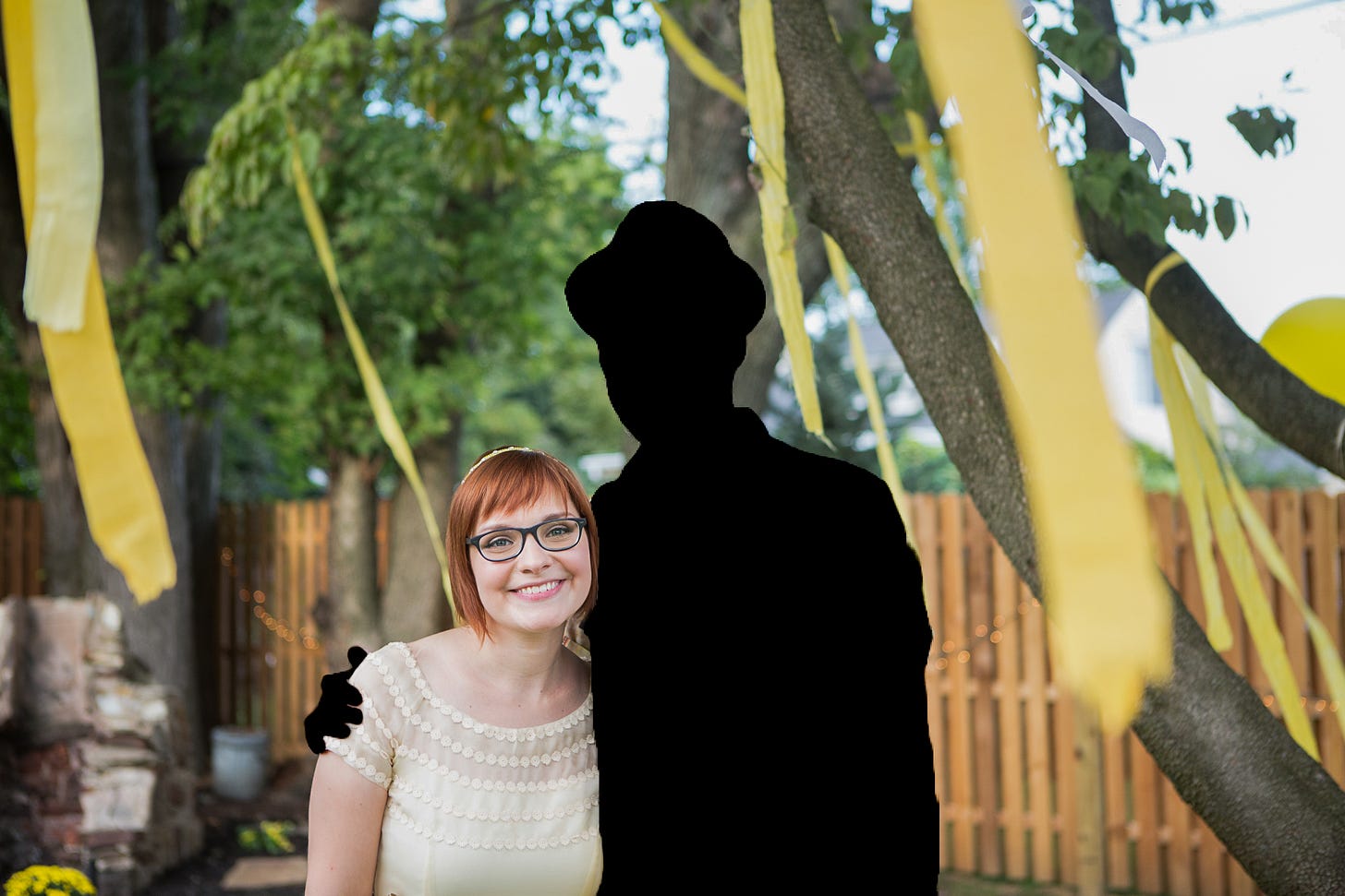 My brother and I smiling at the camera on my wedding day in my backyard. He is silhouetted and wearing a hat.