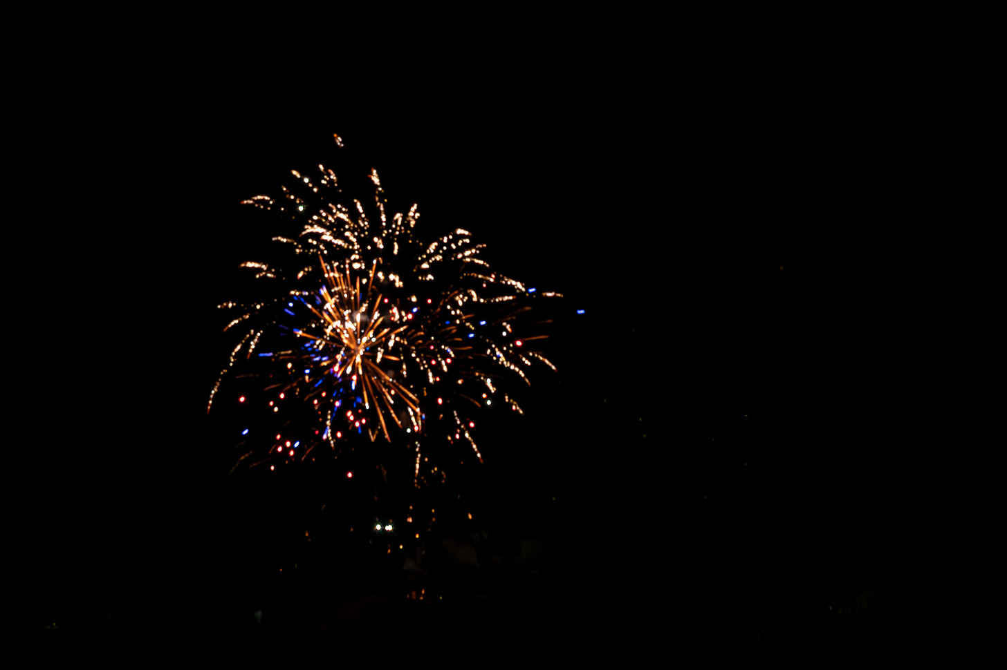 Fireworks exploding in the dark night sky in multi- colors 