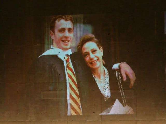 U.S. President Barack Obama speaks about Welles Crowther, pictured on the screen with his mother Alison, during the dedication ceremony at the National September 11 Memorial Museum May 15, 2014 in New York City. The museum spans seven stories, mostly underground, and contains artifacts from the attack on the World Trade Center Towers on September 11, 2001 that include the 80 ft high tridents, the so-called "Ground Zero Cross," the destroyed remains of Company 21's New York Fire Department Engine as well as smaller items such as letter that fell from a hijacked plane and posters of missing loved ones projected onto the wall of the museum. The museum will open to the public on May 21. (Photo by Chang W. Lee-Pool/Getty Images)