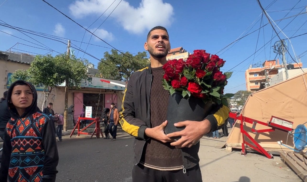 Hussam Abdulhadi, a displaced Palestinian florist, sells flowers, in Rafah