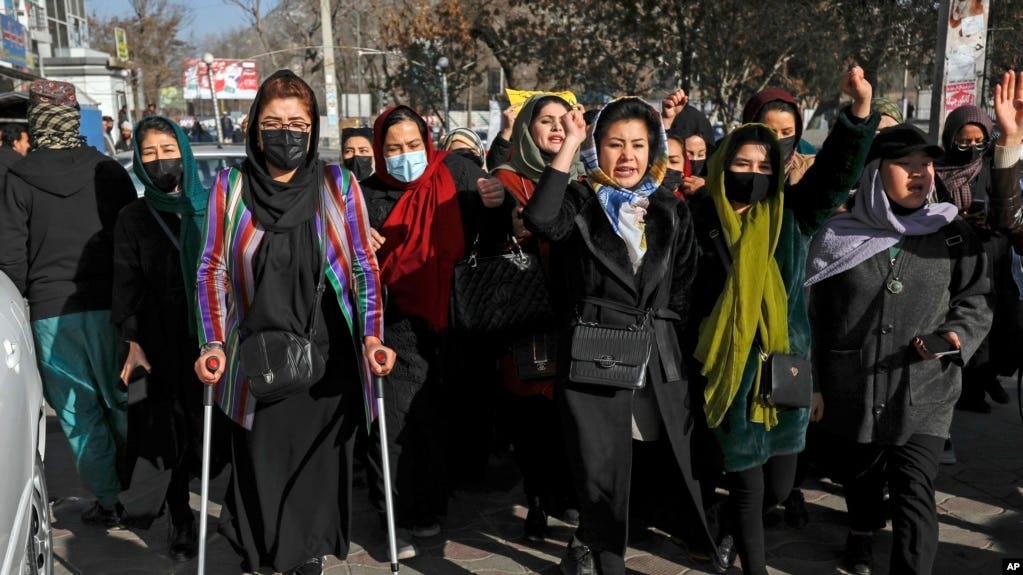 FILE — Afghans protest the ban on university education for women, in Kabul, Afghanistan, Dec. 22, 2022. Four female students say their visa applications to the U.S. and Canadian embassies in Islamabad were denied, despite each presenting fully funded scholarship awards. 