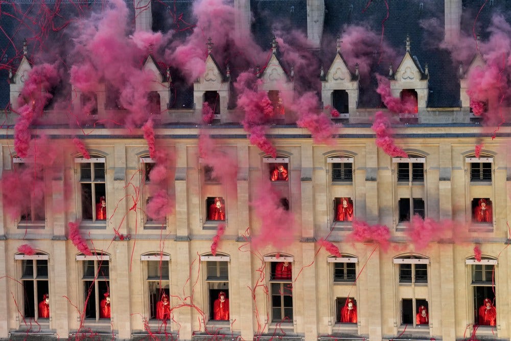 PARIS, FRANCE - JULY 26: Smoke billows near windows as performers participate during the Opening Ceremony of the Olympic Games Paris 2024 on July 26, 2024 in Paris, France. (Photo by Bernat Armangue - Pool/Getty Images)