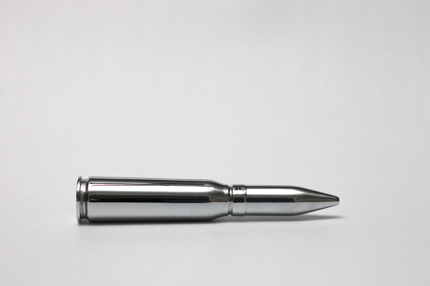A silver bullet on a white background.
