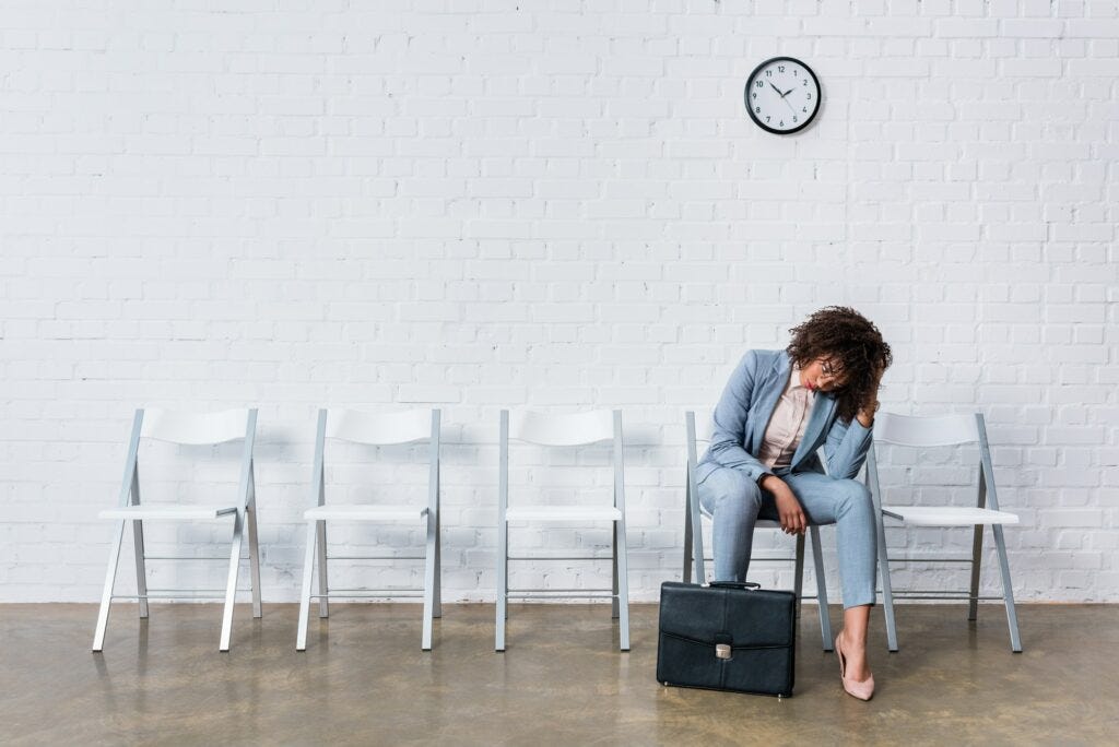 Tired female candidate with briefcase waiting for interview
