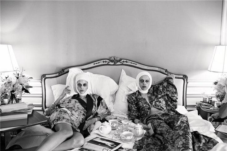 This may contain: black and white photograph of two women in bed