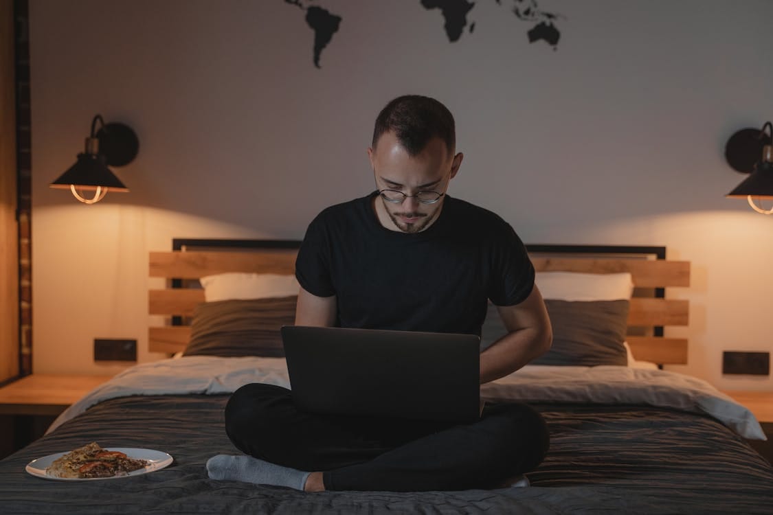 Free Man in Black Crew Neck T-shirt Using Macbook Stock Photo