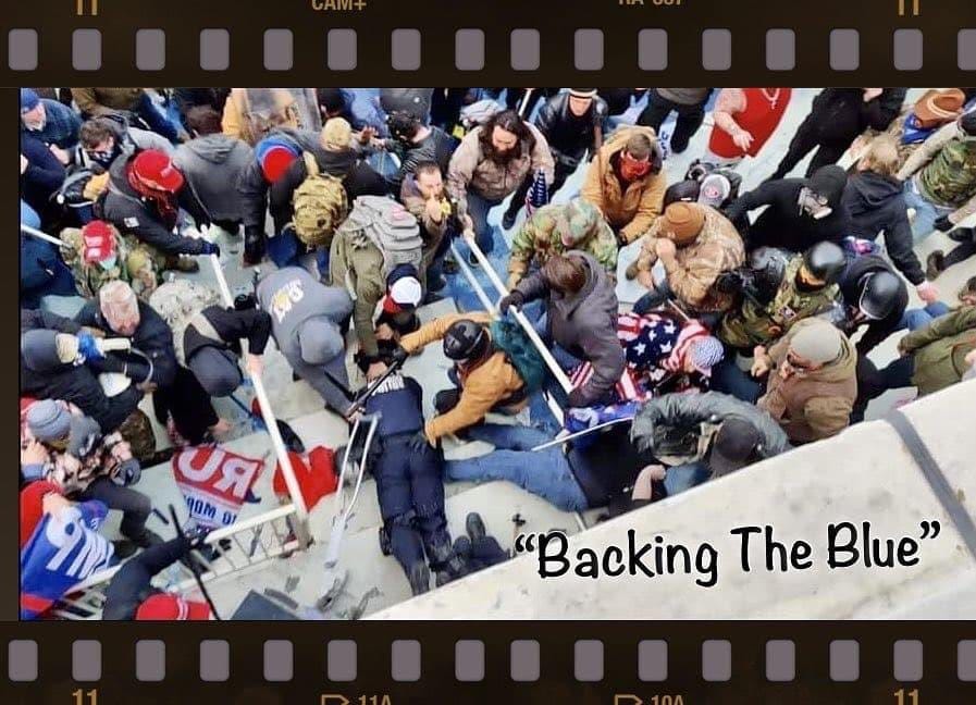 View from above, photo of insurrectionists attacking law enforcement officers on January 6. the LE is down on the ground, being attacked from all sides. The caption reads "backing the blue"