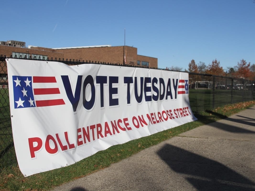 A voting banner hangs outside of Melrose's central voting location at the Melrose Veterans Memorial Middle School Gym. 