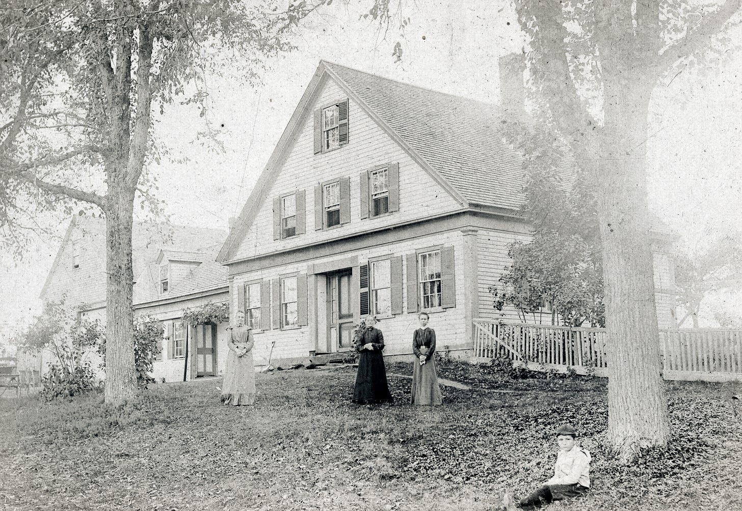 Four people in front of a house