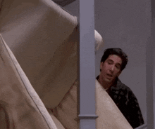 Ross from the TV show "Friends" carrying a couch and demanding a "pivot".