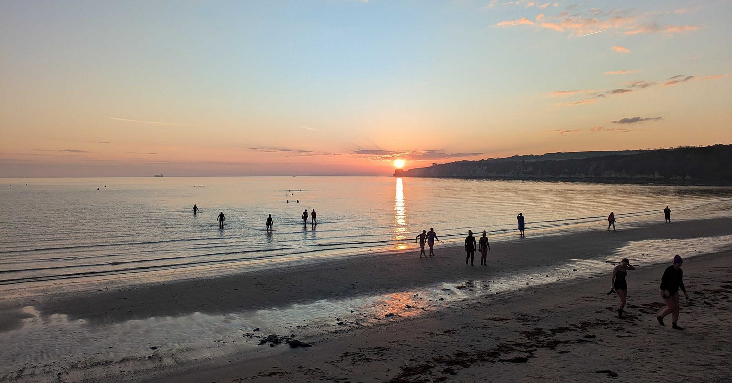 Swimmers head into the sea on the Spring Equinox 2025 onSouth Beach, Studland in Dorset Swimmers head into the sea on the Spring Equinox 2025 onSouth Beach, Studland in Dorset