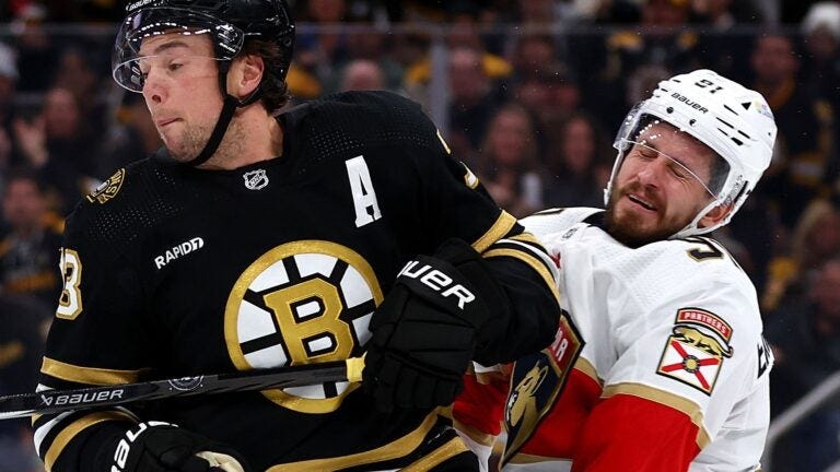 BOSTON, MASSACHUSETTS - OCTOBER 30: Charlie McAvoy #73 of the Boston Bruins commits an illegal check to the head against Oliver Ekman-Larsson #91 of the Florida Panthers during the third period at TD Garden on October 30, 2023 in Boston, Massachusetts.