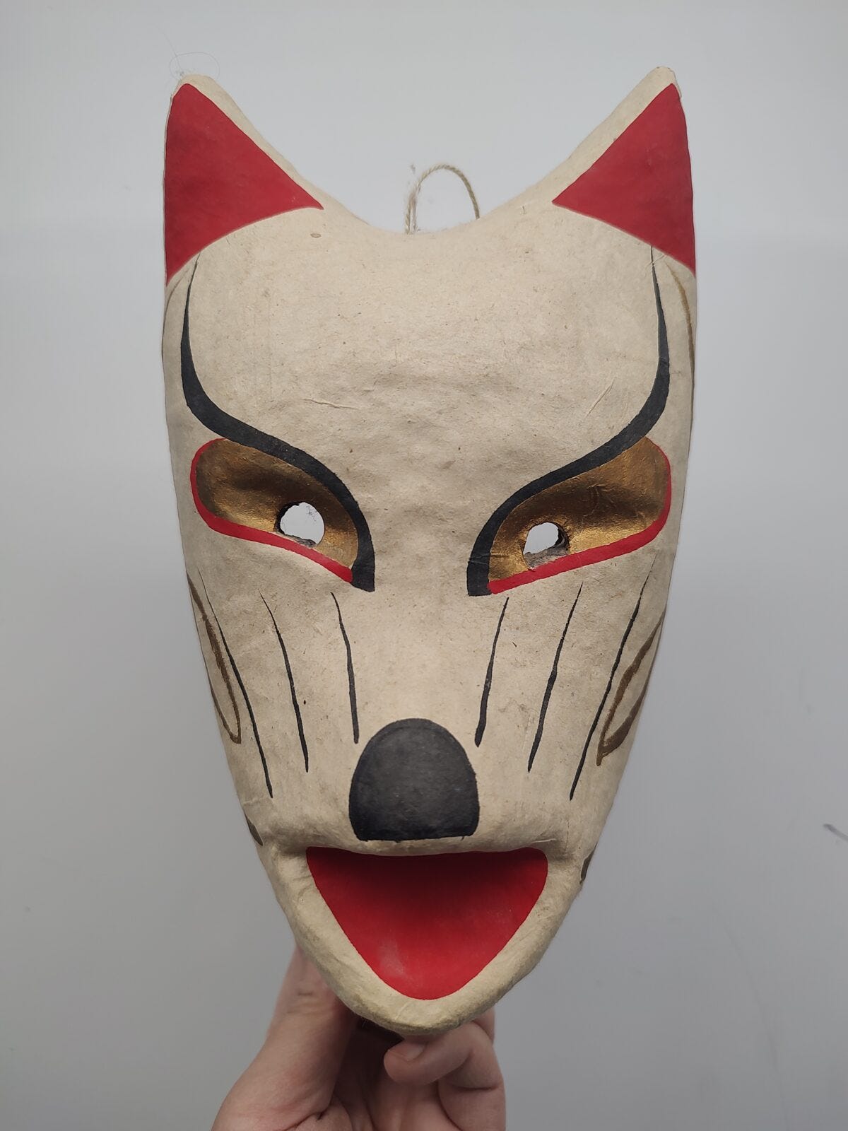 A paper mache mask from Japan I (Helen) inherited from a dear friend: Foxes (kitsune) in Japanese folklore posses paranormal abilities. Commonly depicted as shape shifting tricksters, they are also associated with Inari, a Shinto spirit and serves as its messengers. These masks are found in shrines and are sold to people as they dress up in festivals during the rice harvesting season.