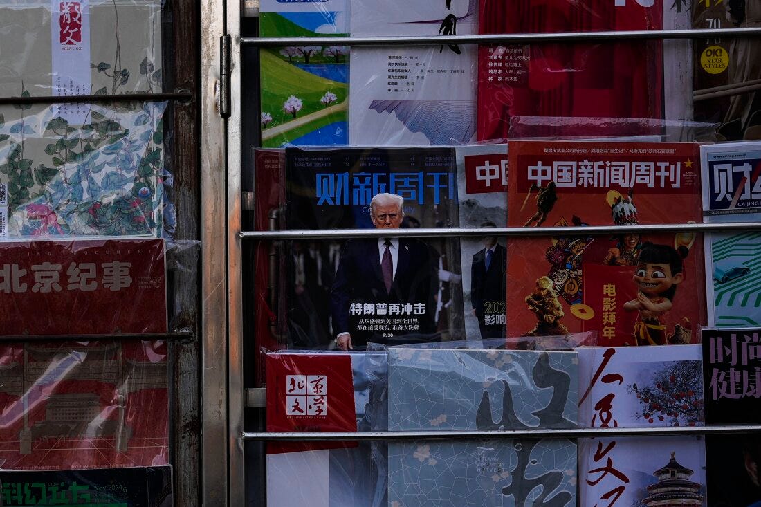 A magazine carrying a front cover of President Donald Trump with the words "Trump shock again" on display with other magazines at a bookstand in Beijing on Tuesday, Feb. 4.