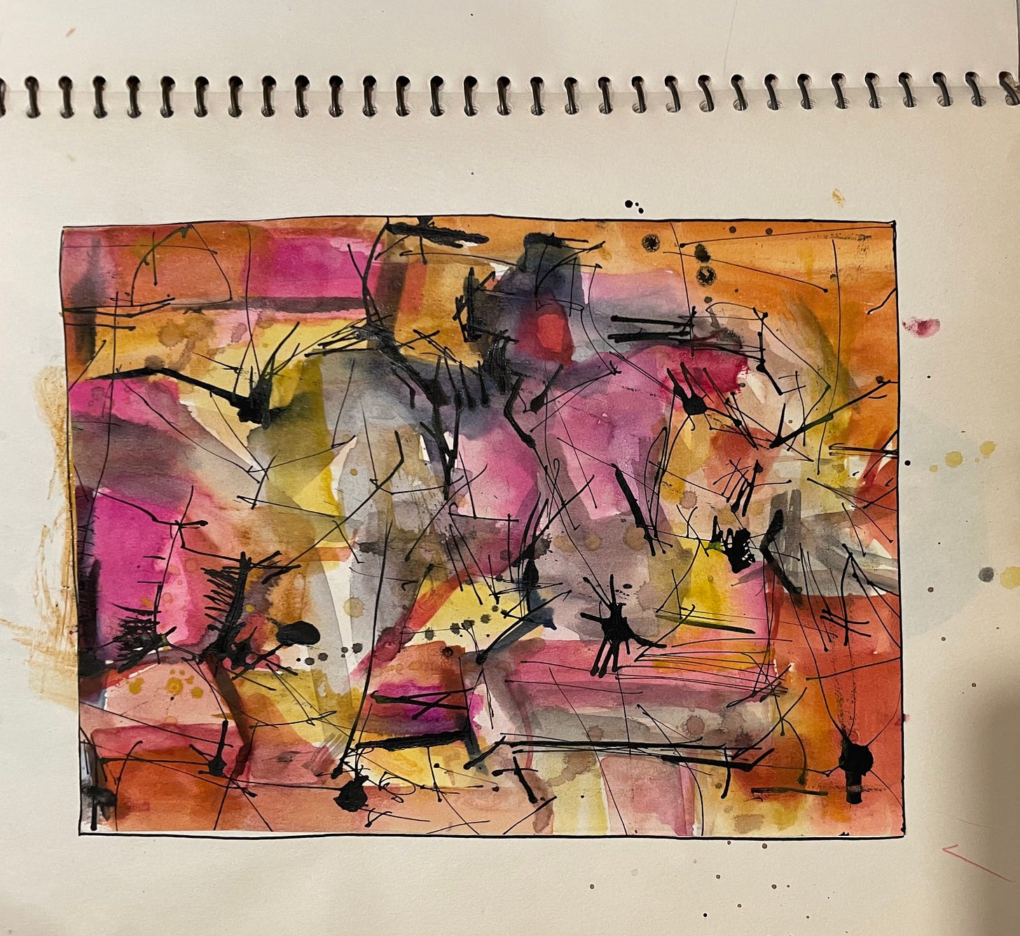 A spiral notebook page with a painting in watercolor and ink. The base is geometric stains in pinks, orange, and yellow, overmarked by clusters of lines, bursts, and drops of black ink. The left edge has an orange stain bleeding over, and the top, bottom, and right have a few errant splatterings.