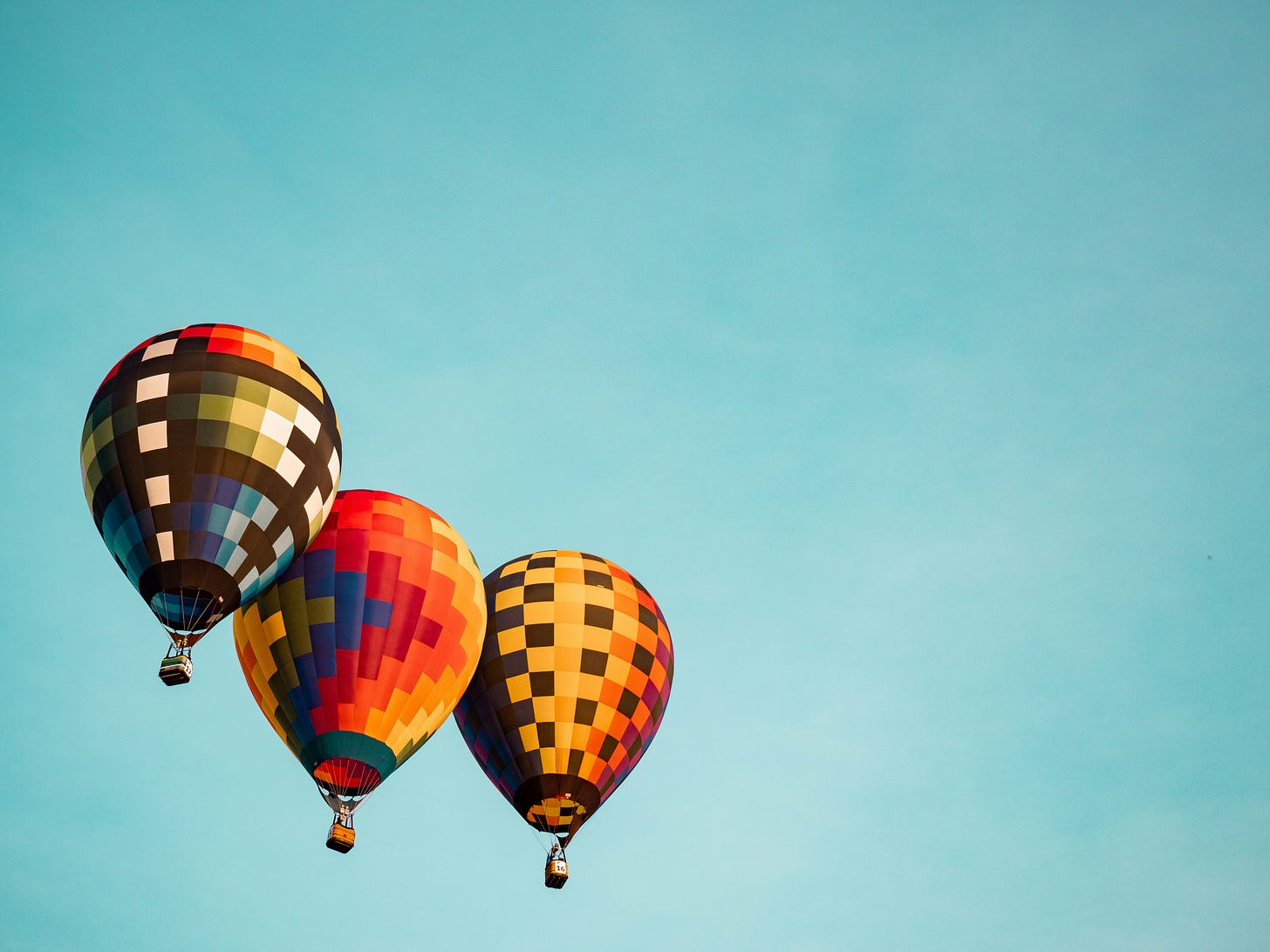 three hot air balloons in the air