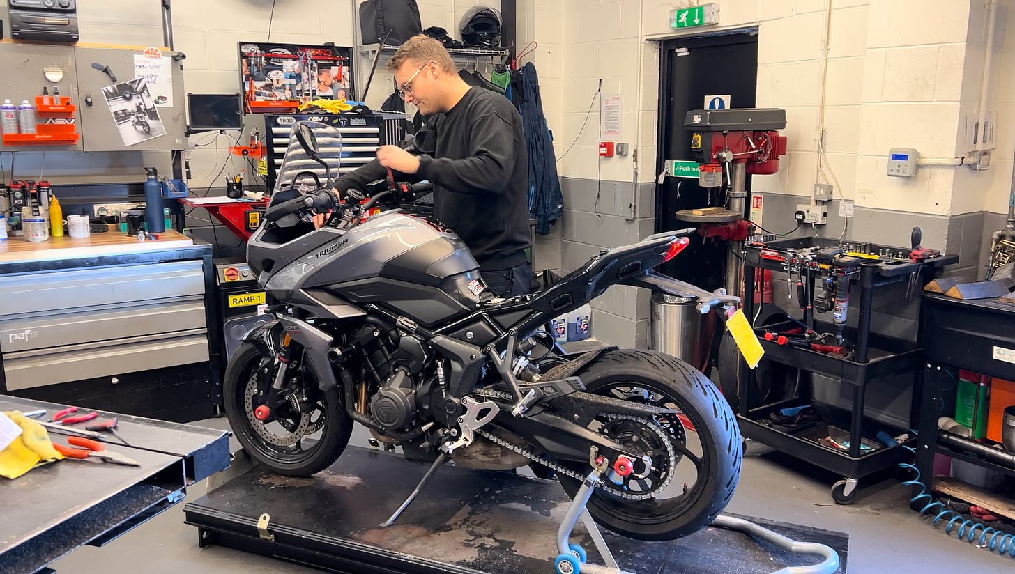 A person called Jamie works on a triumph for 660 sport in a workshop in Wellingborough.
