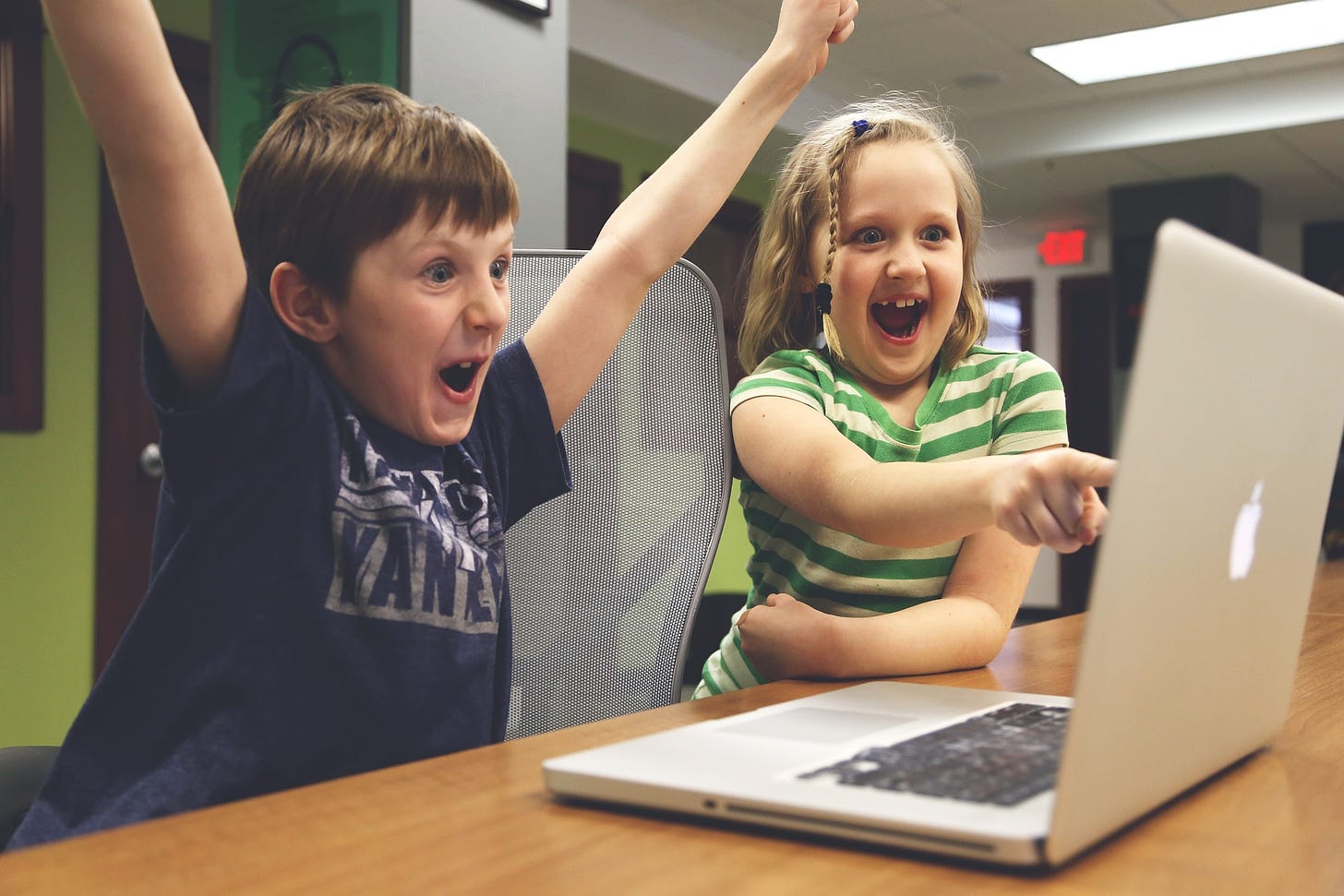 Children at a laptop celebrating success