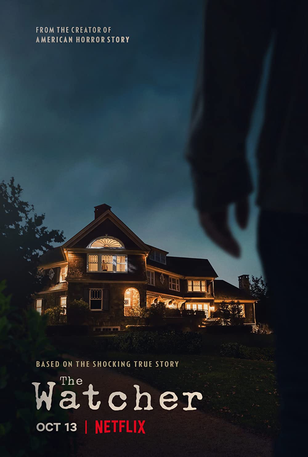 A photo of a (haunted?) house in the background with an ominous hand in the foreground. Text reads, “From the creator of American Horror Story, Based on the Shocking True Story, The Watcher | Oct 13 Netflix”