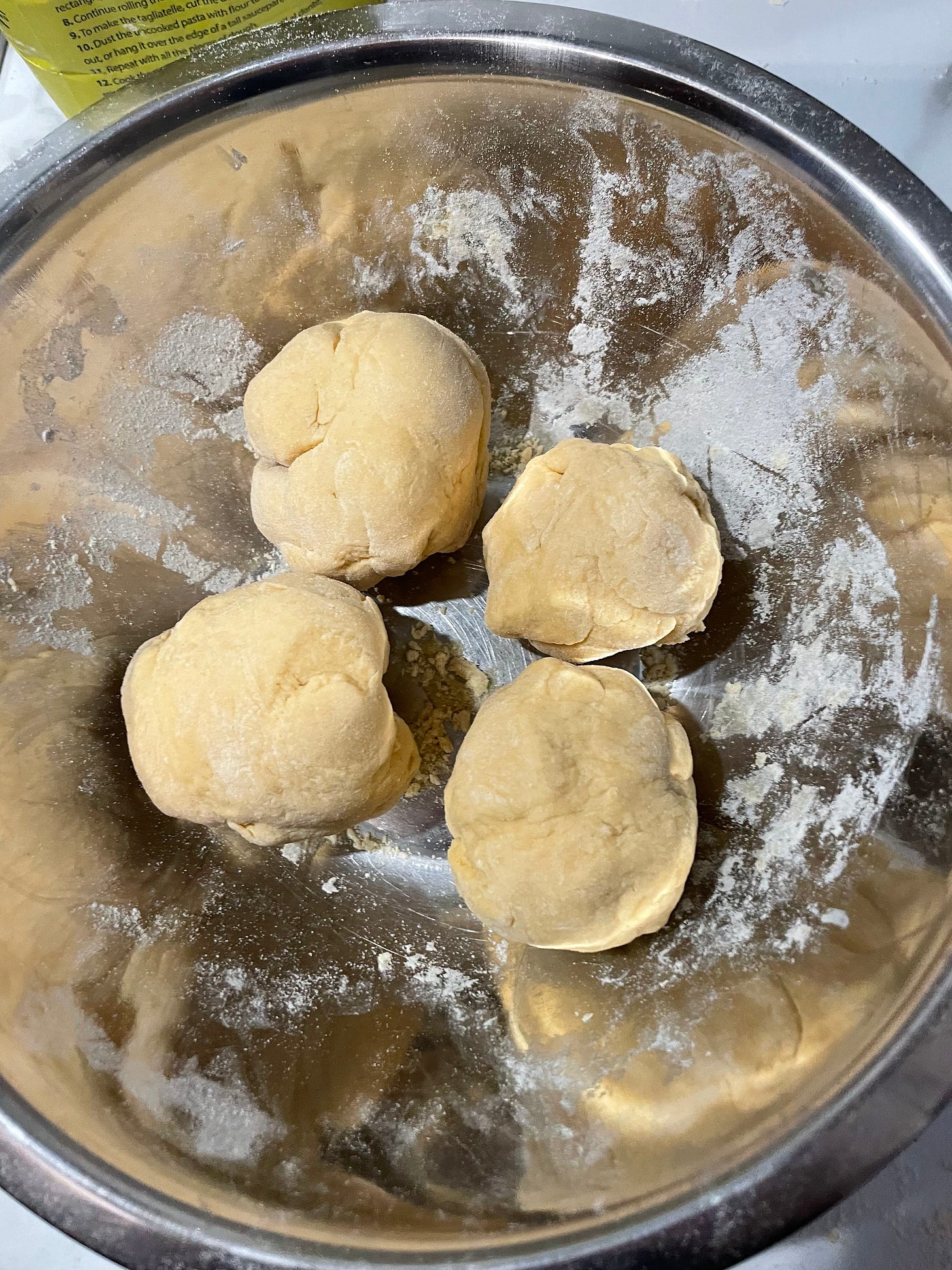 Showing how pasta dough should look when it's divided into 4 bundles and allowed to cool before it's run through a pasta machine.