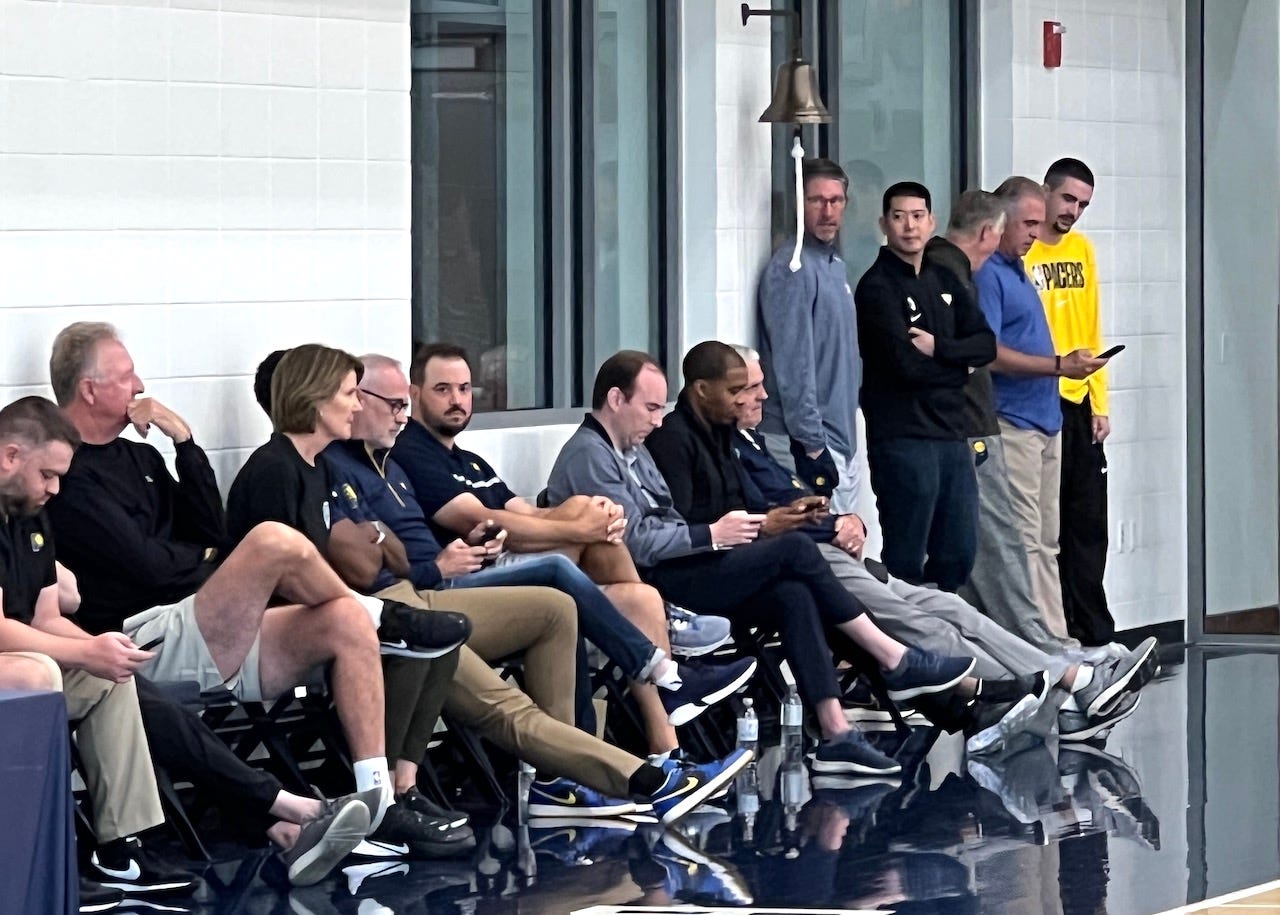Pacers president Kevin Pritchard (right) looks at his phone after a draft workout.