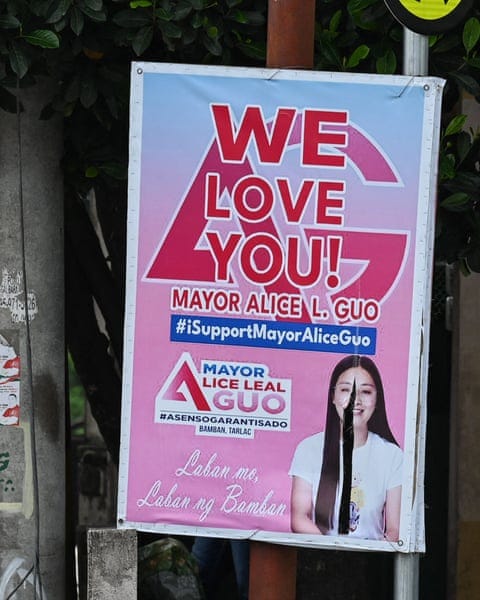 A poster with a photo of Alice Guo smiling, with the words “We love you! Mayor Alice L Guo #iSupportMayorAliceGuo”, attached to a pole