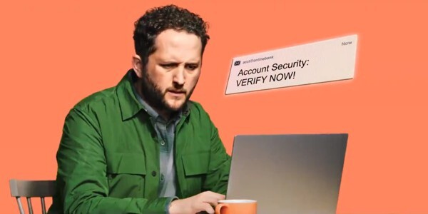 Man using laptop read a scam message 'Account Security - Verify NOW'