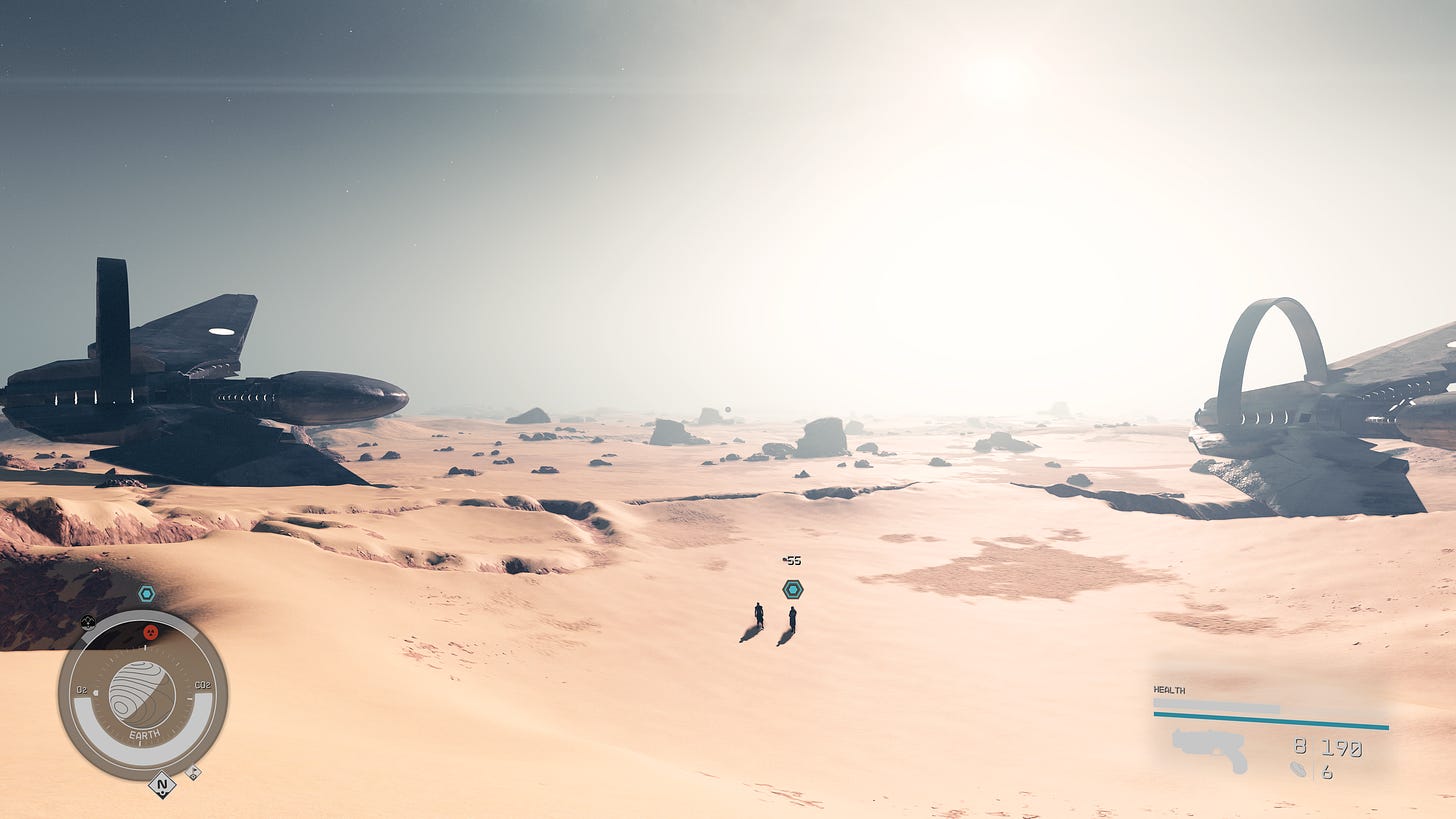Two figures standing in a valley of sand, flanked by two large, futuristic looking spaceships