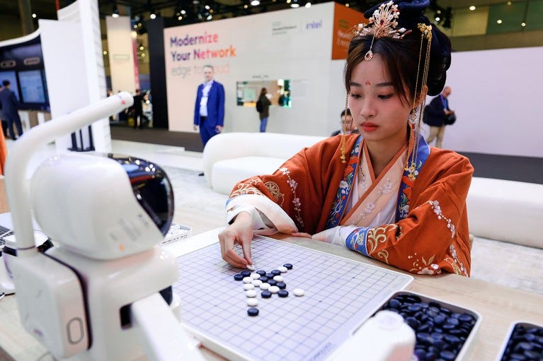 A woman wearing traditional Chinese clothing is playing Go with a robot at the Mobile World Congress, 2024.