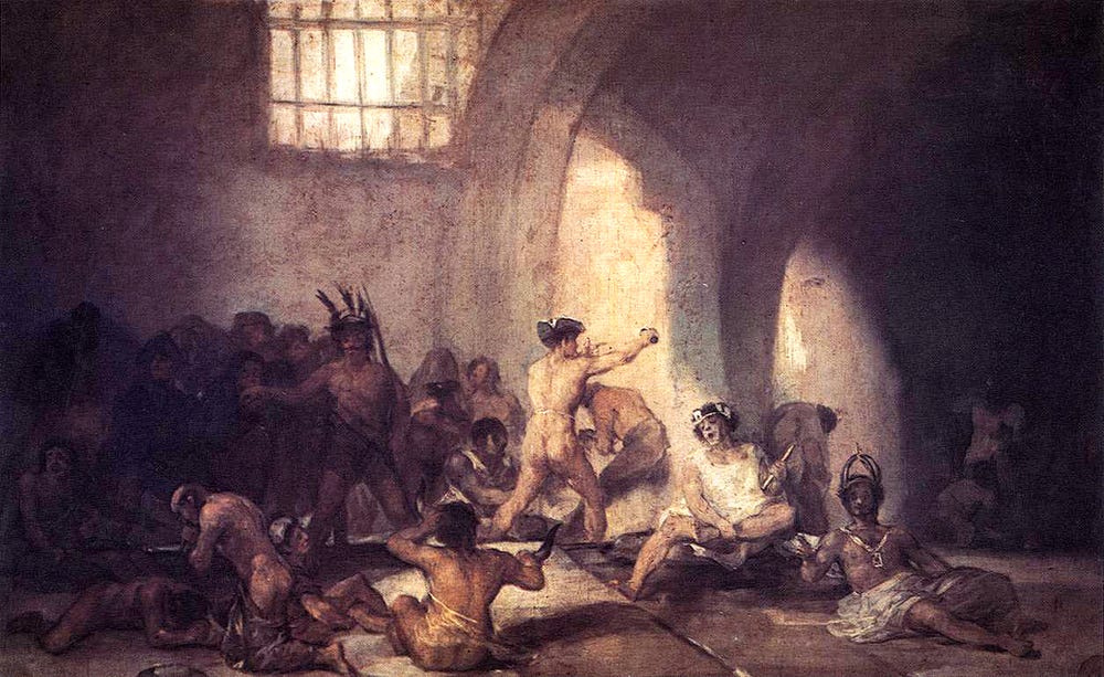 A painting of a madhouse by Franscico Goya. A group of people are painted In a room, in various states of movement.