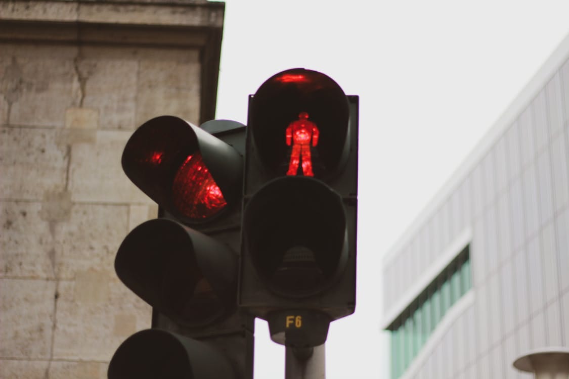 Free Red traffic light in Berlin with urban architecture backdrop. Stock Photo