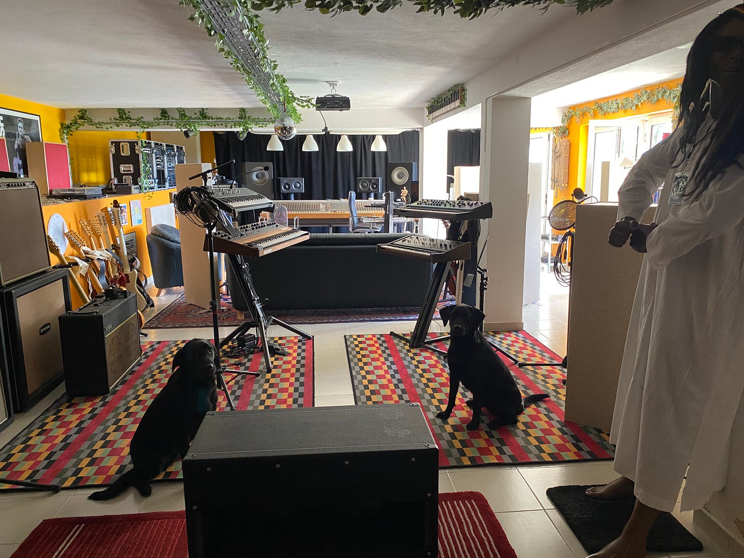 a recording studio with keyboards, analogue console and instruments
