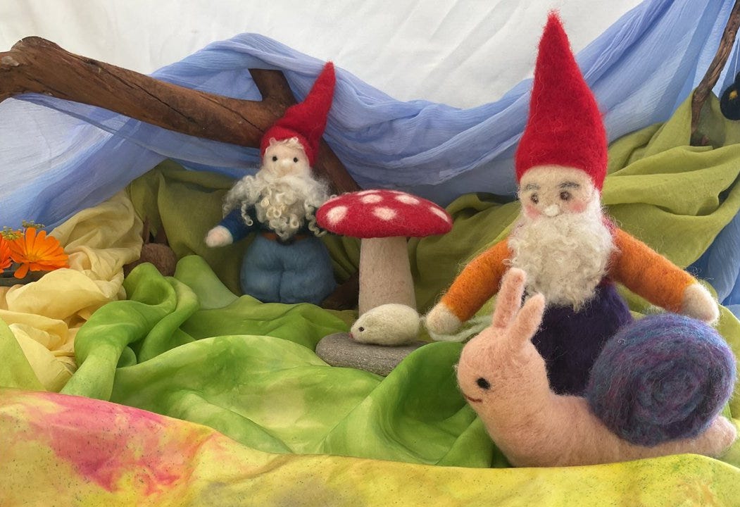 felted gnomes, snail and toadstool with fabric backdrop