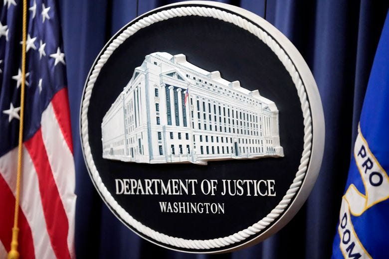 FILE &#8211; The logo for the Justice Department is seen before a news conference at the Department of Justice, Aug. 23, 2024, in Washington. (AP Photo/Mark Schiefelbein, File)