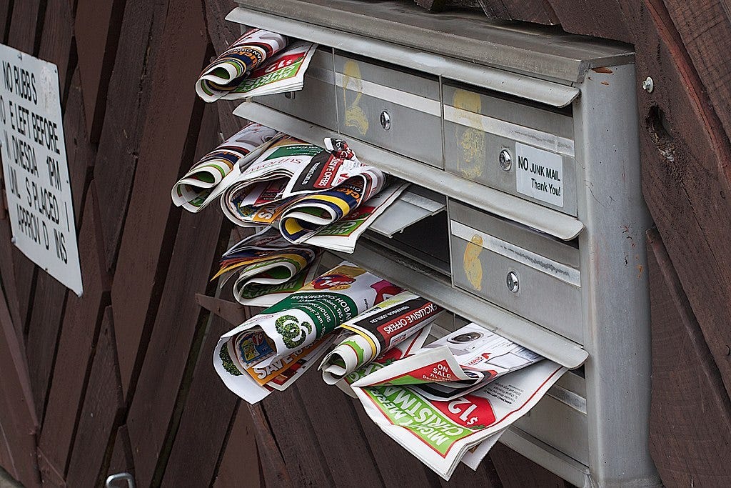 Photography of mailboxes overloaded with unsollicited advertising