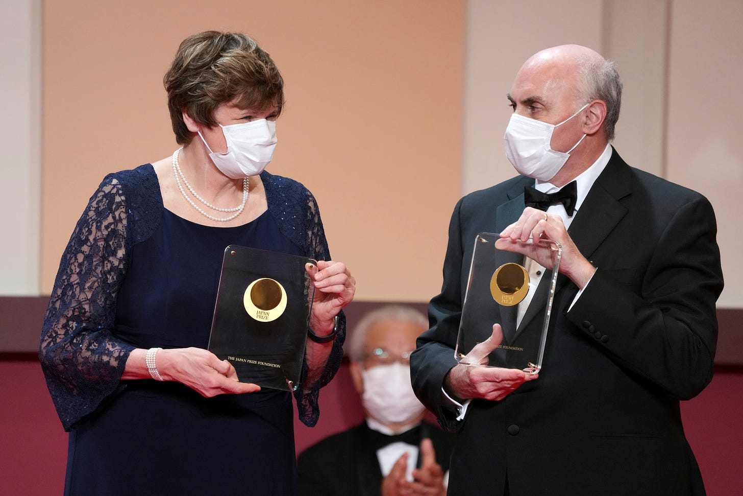 Japan Prize 2022 laureates Hungarian-American biochemist Katalin Kariko, left, and American physician-scientist Drew Weissman, right, pose with their trophies during the Japan Prize presentation ceremony Wednesday, April 13, 2022, in Tokyo. 