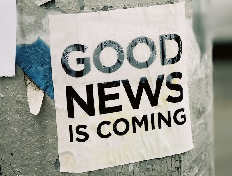 white Good News Is Coming paper on wall