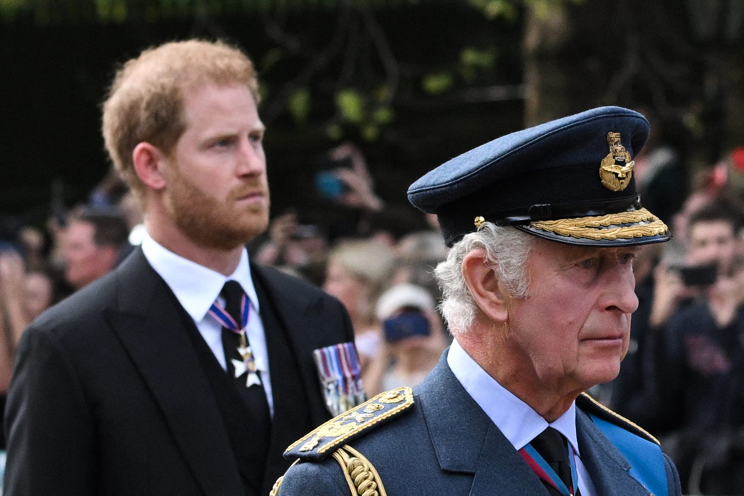 king charles walks behind the queen's coffin with prince harry