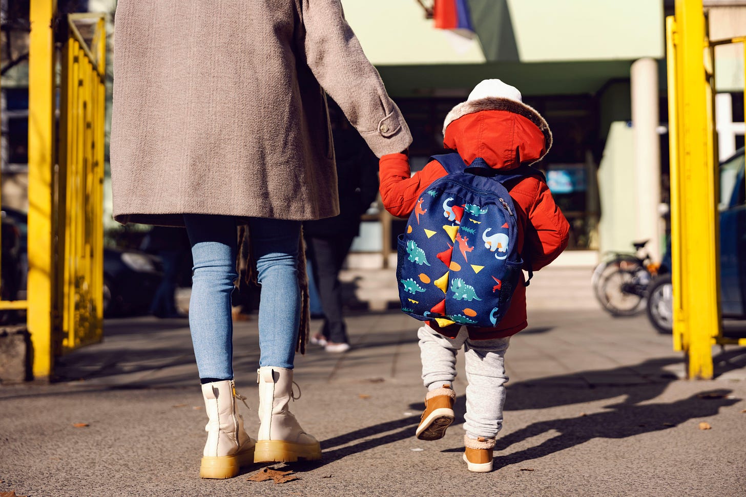 Mother taking young child to nursery school 