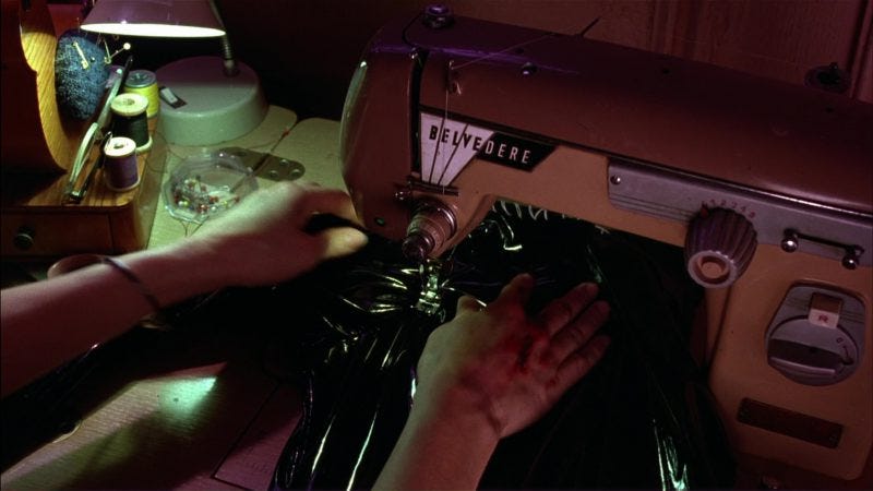A screencap from the 1992 movie "Batman Returns," during which Michelle Pfieffer makes her own Catwoman outfit on a Belvedere sewing machine.