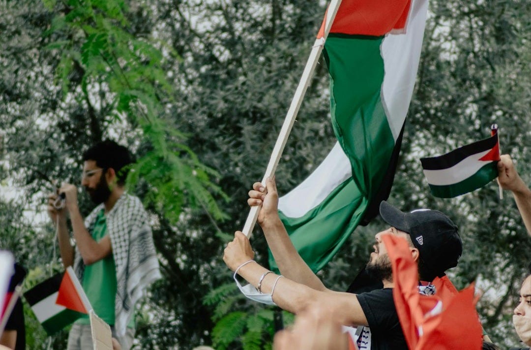 people holding flags during daytime people holding flags during daytime