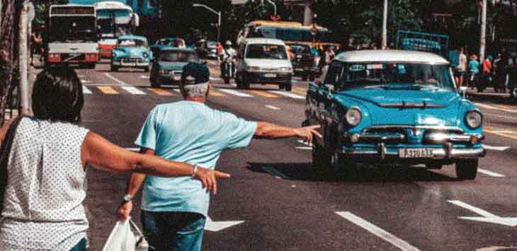 Photo of two people hailing a taxi.