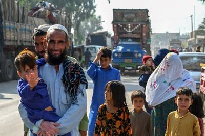 An Afghan refugee family living in Pakistan arrives outside the United Nations High Commissioner for Refugees (UNHCR) repatriation centre, near Peshawar on October 25. AFP
